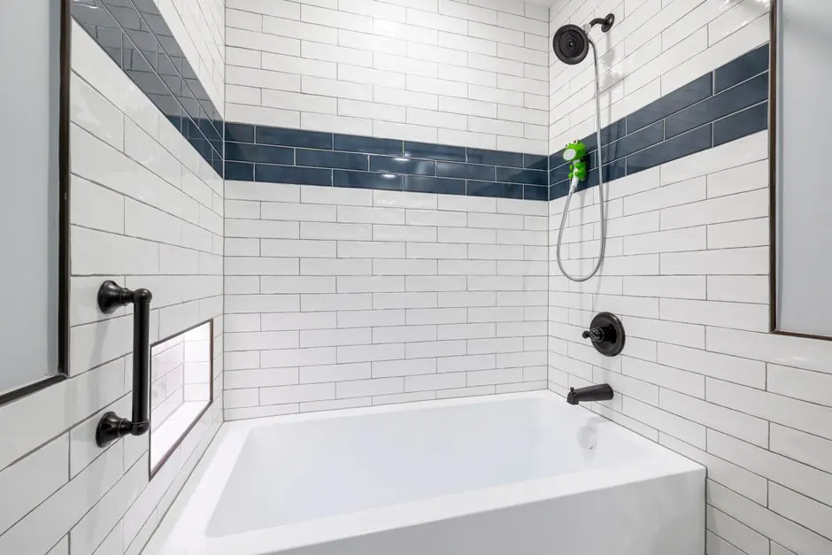Sleek, minimalist bathroom with white and blue tiles and contemporary fixtures.